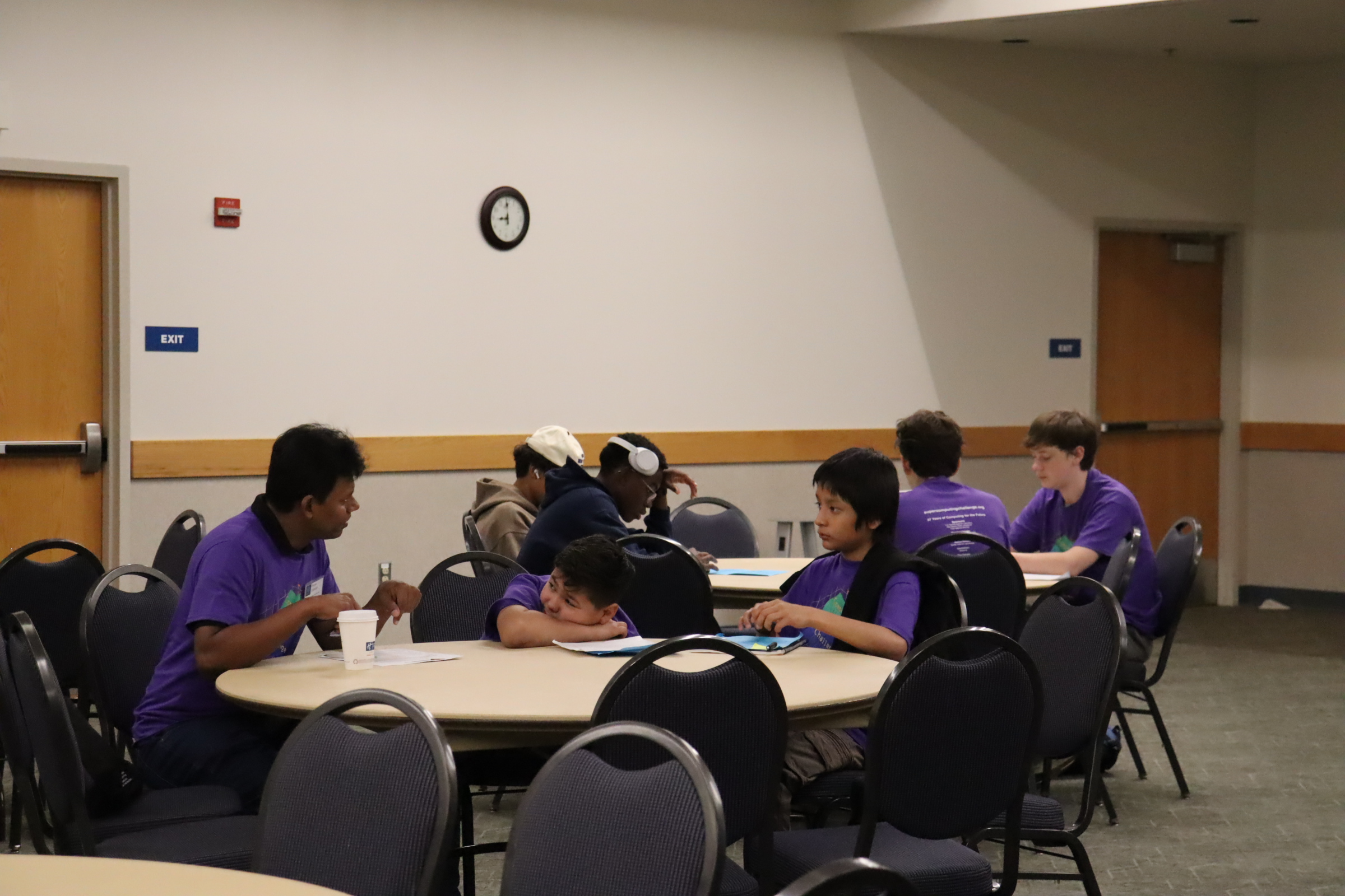 A small group talking around a table during Kickoff
